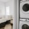 stacked washer/dryer units next to bedroom