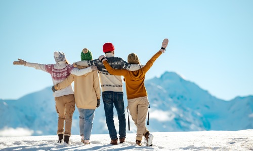 group in the winter snow hugging