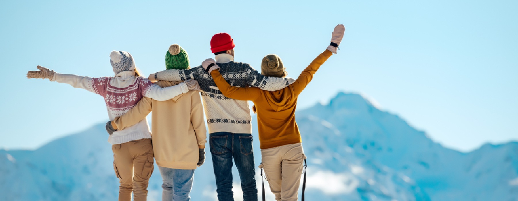 group of friends hugging in winter clothing